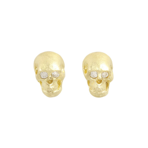 18k Gold skull-shaped earrings with embedded stones on a white background